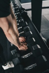 Man exercising with dumbbells in a gym